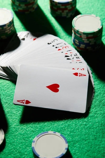 Live baccarat table with dealer and cards displayed on screen